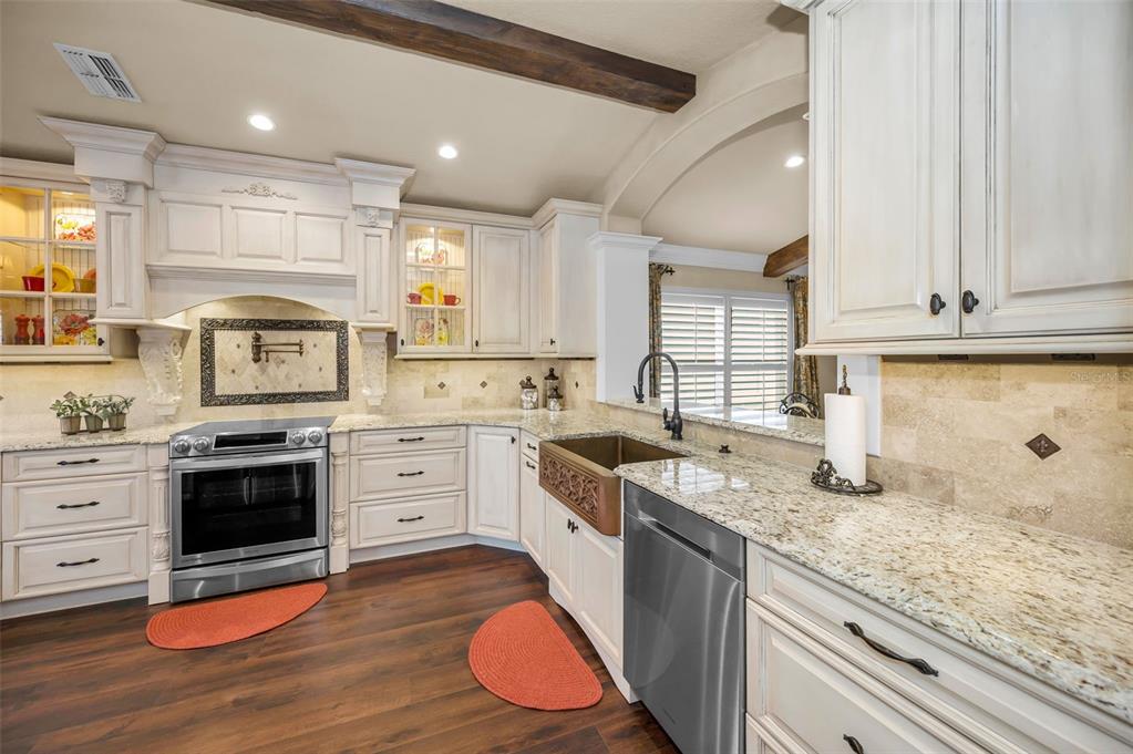 1326 Winding Willow Drive Trinity, FL 34655 - Photo 21 of 100 a kitchen with granite countertop a sink cabinets stainless steel appliances and a counter space
