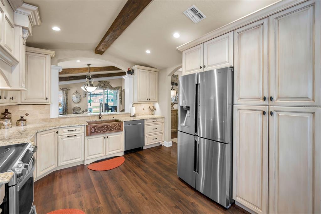 1326 Winding Willow Drive Trinity, FL 34655 - Photo 22 of 100 a kitchen with stainless steel appliances a refrigerator sink and cabinets