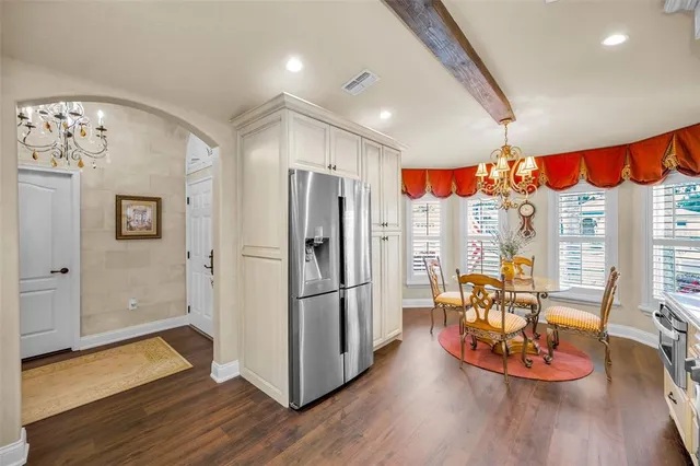 a living room with patio furniture and a large window