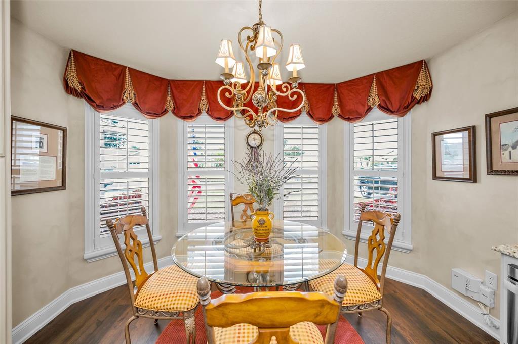 1326 Winding Willow Drive Trinity, FL 34655 - Photo 24 of 100 a view of a dining room with furniture and wooden floor