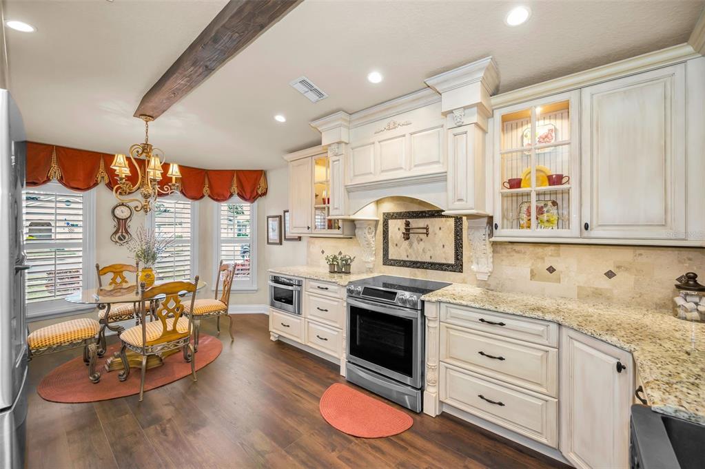 1326 Winding Willow Drive Trinity, FL 34655 - Photo 25 of 100 a kitchen with stainless steel appliances granite countertop a stove and white cabinets