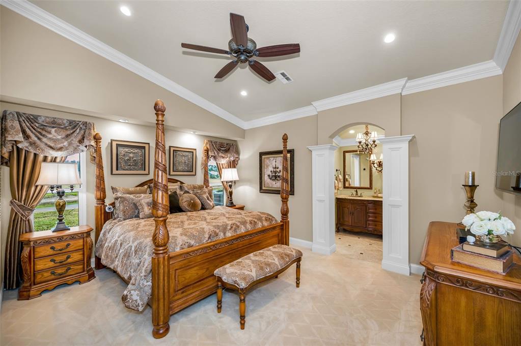 1326 Winding Willow Drive Trinity, FL 34655 - Photo 27 of 100 a bedroom with a bed and a chandelier
