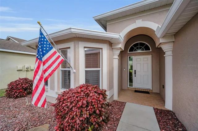 a view of a dining room with furniture wooden floor and chandelier
