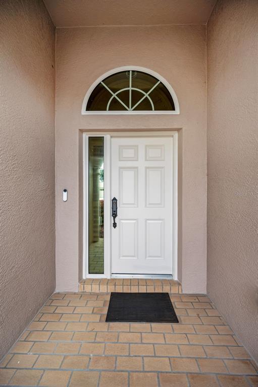 1326 Winding Willow Drive Trinity, FL 34655 - Photo 9 of 100 a front view of a house with a door