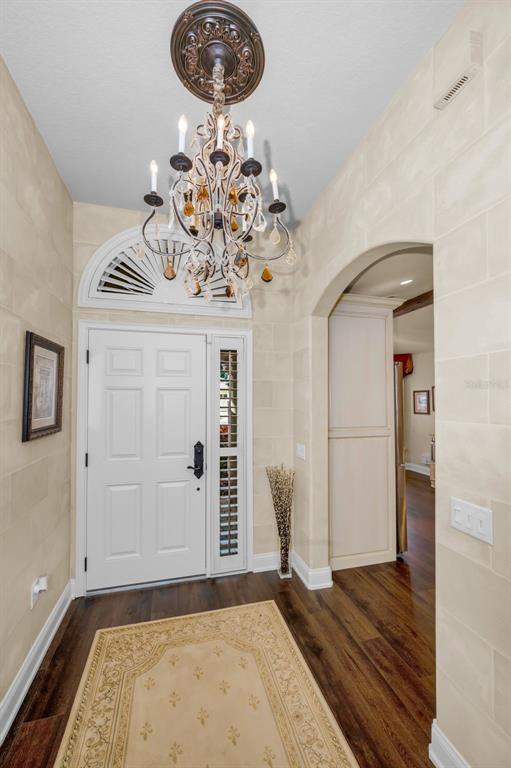 1326 Winding Willow Drive Trinity, FL 34655 - Photo 10 of 100 a view of a livingroom with wooden floor and a chandelier