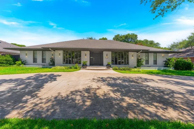 a view of house with outdoor space and swimming pool