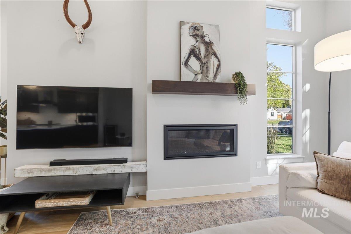 2129 North 34th Street Boise, ID 83703 - Photo 8 of 50 Living area featuring a glass covered fireplace and light wood-style flooring