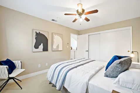 a bedroom with a bed and a chandelier
