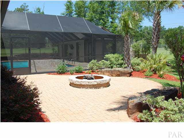 4380 Berryhill Road Pace, FL 32571 - Photo 19 of 24 View of north garden & fire pit. Custom landscaping surrounds this area.