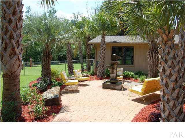 4380 Berryhill Road Pace, FL 32571 - Photo 20 of 24 View of the east garden & fountain. Custom paver stone & lush landscaping surrounds this area as well.