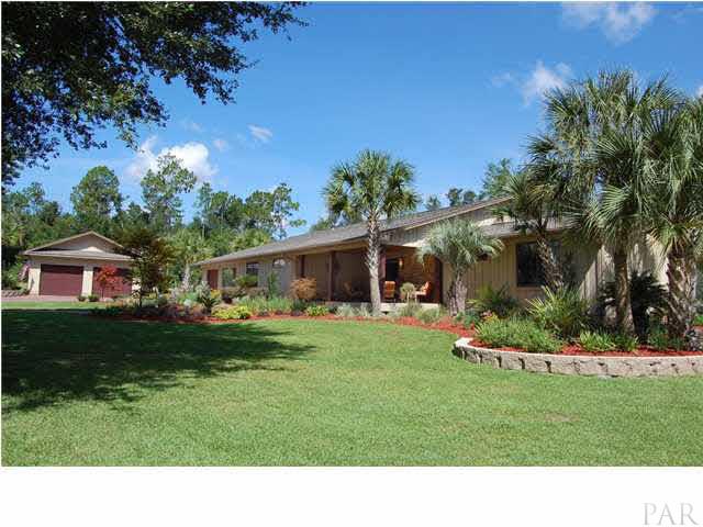 4380 Berryhill Road Pace, FL 32571 - Photo 22 of 24 Two car oversized detached garage has 12' ceilings, custom California Red Wood doors & Anderson windows.