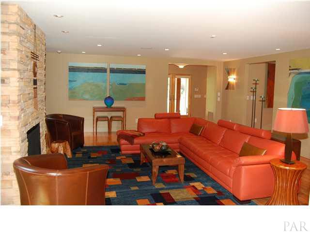 Fireplace surround is dry stack ledge stone. Anderson full view glass doors in foyer. Custon wall sconce & recessed lighting.