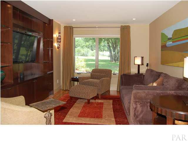Den/theater room. Custon theater sconce & dimmable recessed lights. All cabinets throughout home by Paulk Woodworking in Pensacola. 52" TV conveys.