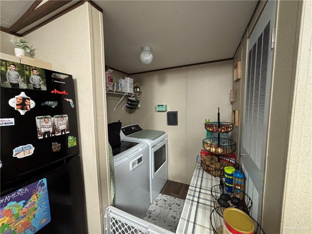 4415 Addison Drive Edinburg, TX 78542 - Photo 4 of 12 Laundry area featuring independent washer and dryer, wood finished floors, and a heating unit