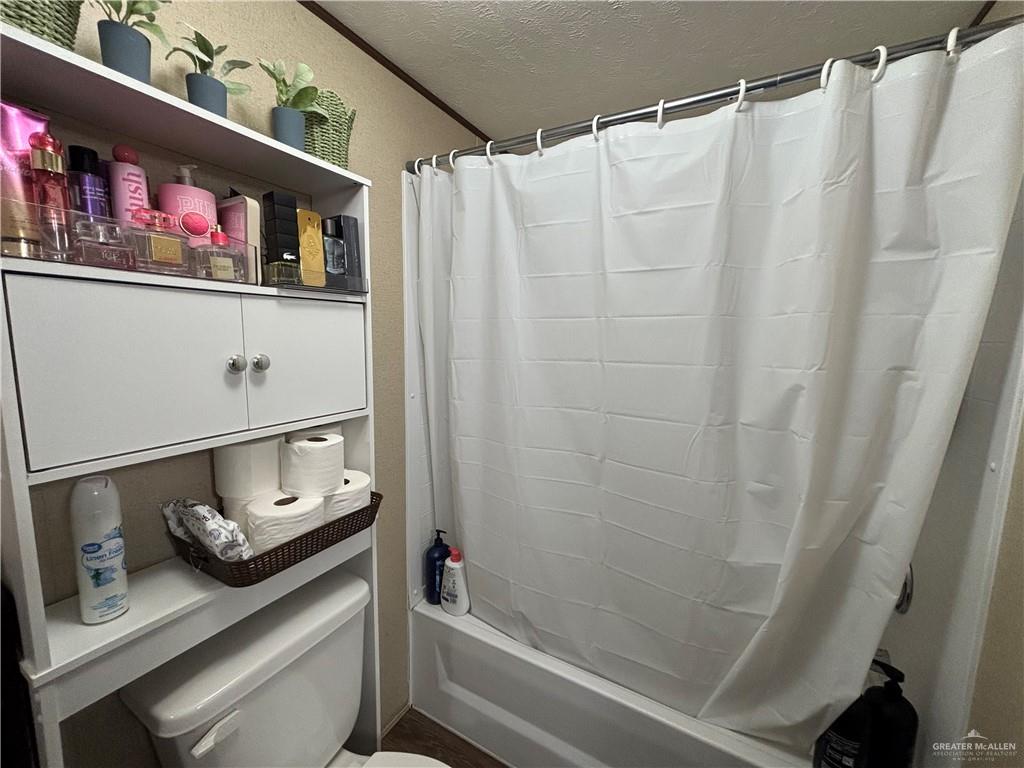4415 Addison Drive Edinburg, TX 78542 - Photo 8 of 12 Full bath featuring shower / bathtub combination with curtain and a textured ceiling