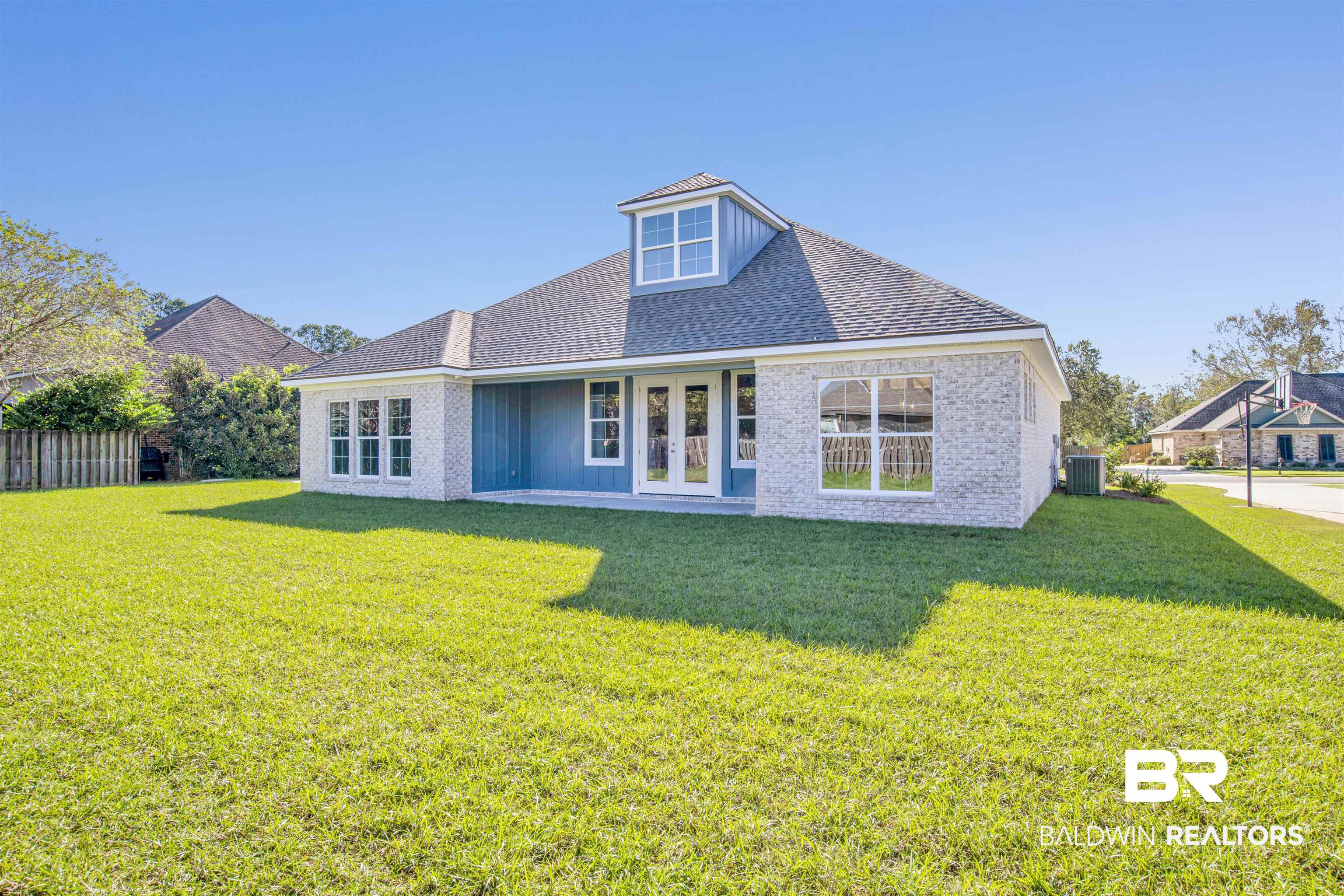 9687 Widgeon Court Daphne, AL 36526 - Photo 34 of 40 Back of property with a lawn, central AC, and french doors