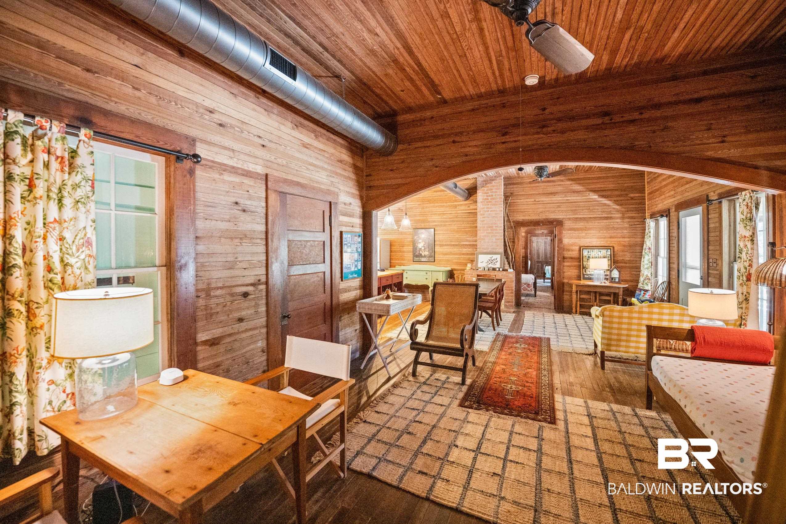 30671 Magnolia Street Elberta, AL 36530 - Photo 36 of 68 Dining area with arched walkways, wooden ceiling, wood finished floors, and wooden walls