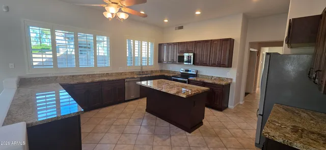 a kitchen with granite countertop a sink and a window