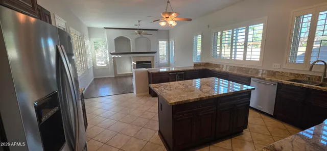 a view of a hallway with wooden floor and a chandelier