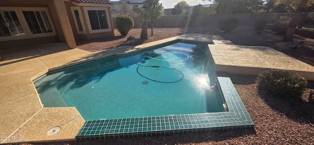 a kitchen with granite countertop a refrigerator a stove and a sink