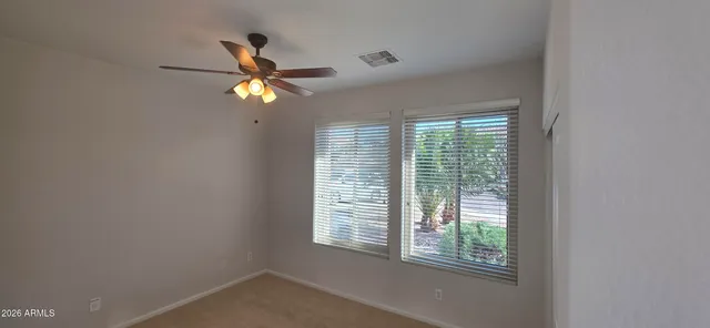 a view of a house with backyard and trees