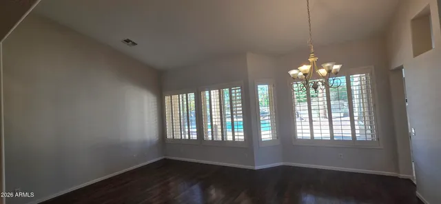 a kitchen with granite countertop a refrigerator a sink a stove and island