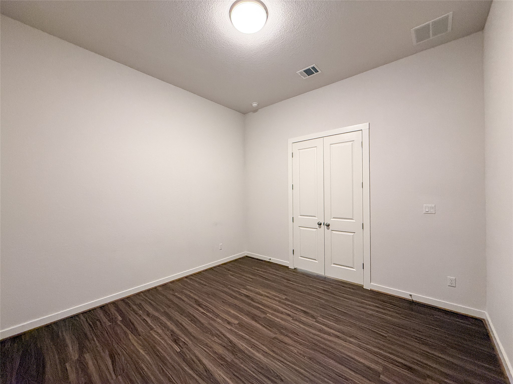 249 Heartleaf Road San Marcos, TX 78666 - Photo 30 of 38 Rich hardwood floors complement the simple, clean lines of this inviting space.