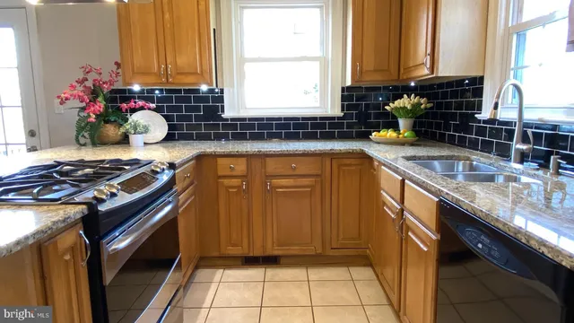 a kitchen with a sink stove and cabinets