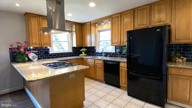 a kitchen with a refrigerator and a stove