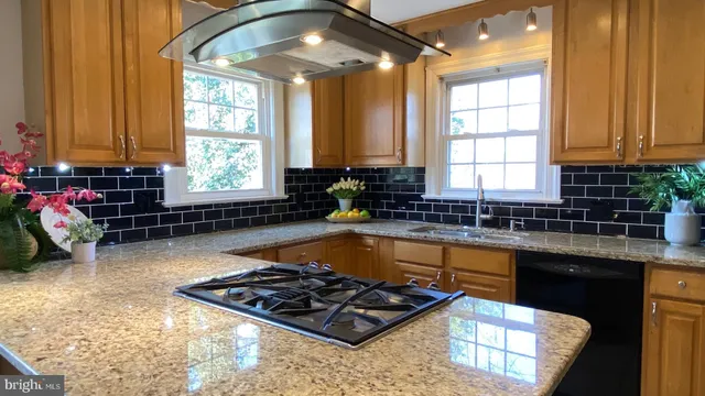 a kitchen with sink a window and cabinets