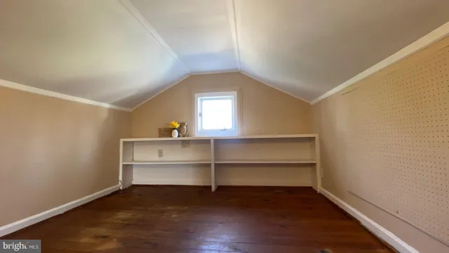a view of room with wooden floor and window