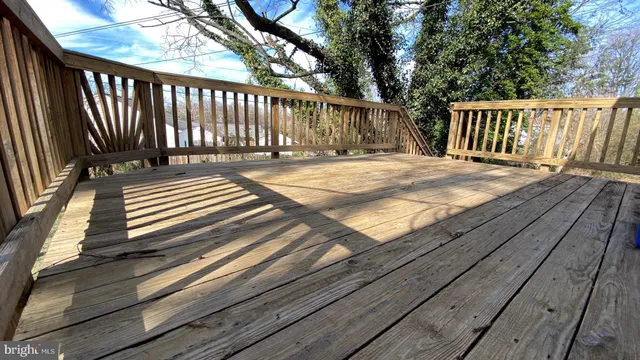 a view of deck with wooden floor and fence and a floor to ceiling window