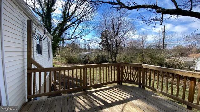 a view of balcony with wooden floor and fence