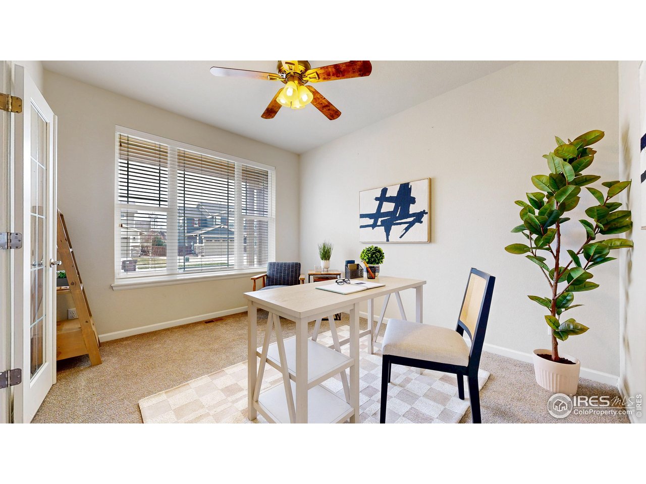 6748 Rainier Road Timnath, CO 80547 - Photo 11 of 34 a living room with a table and a potted plant