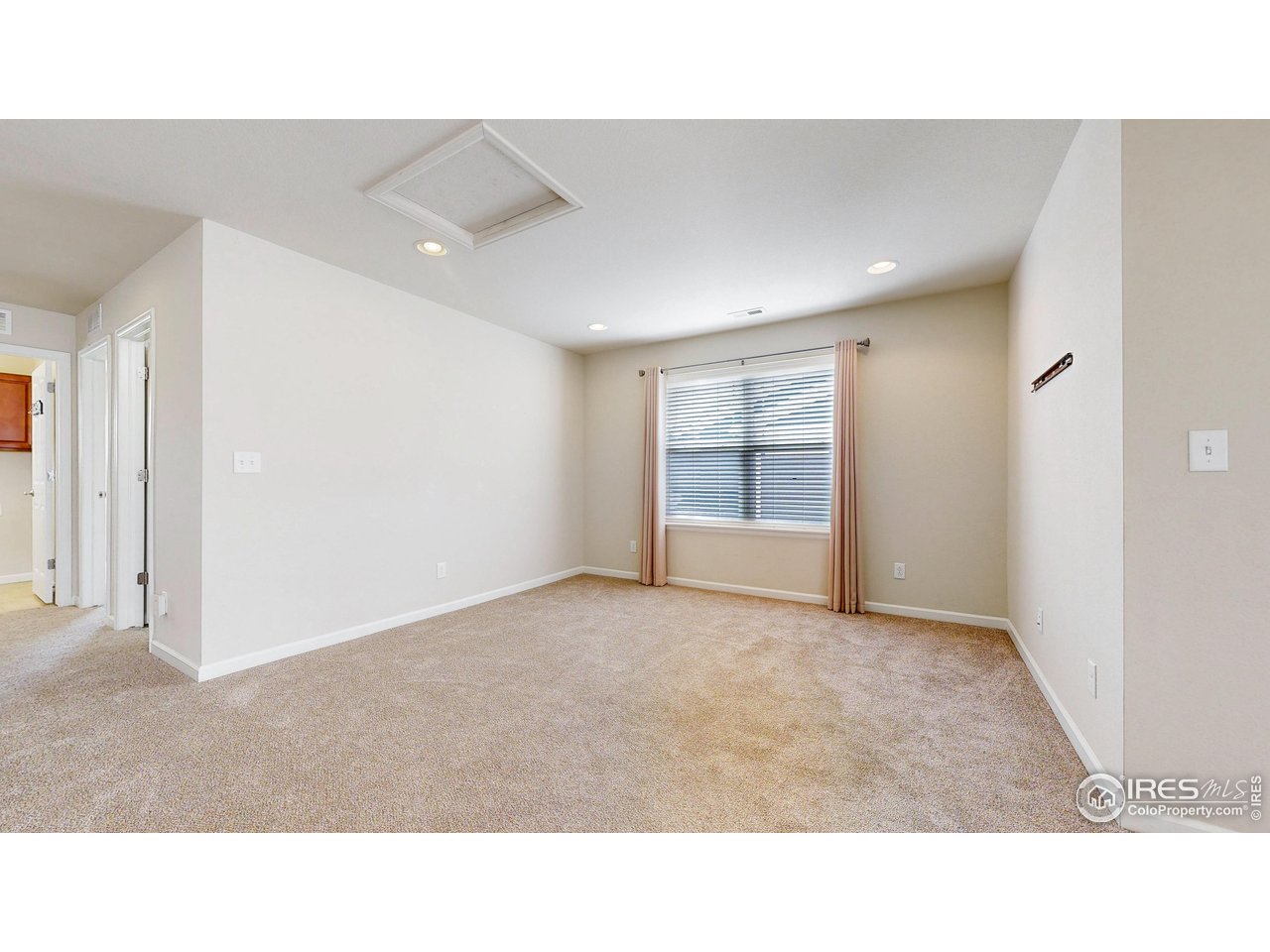 6748 Rainier Road Timnath, CO 80547 - Photo 18 of 34 a open hall with a floor to ceiling window
