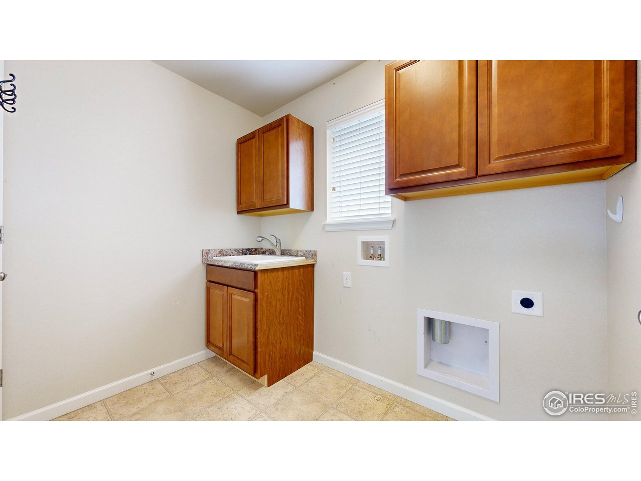 6748 Rainier Road Timnath, CO 80547 - Photo 26 of 34 Upper laundry with sink, cabinets and storage closet