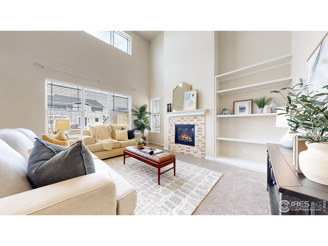 6748 Rainier Road Timnath, CO 80547 - Photo 3 of 34 a living room with furniture and a fireplace