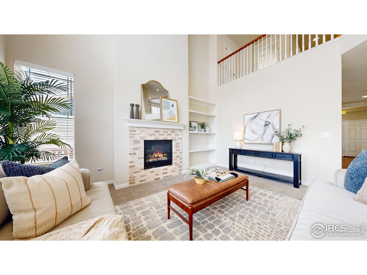 6748 Rainier Road Timnath, CO 80547 - Photo 4 of 34 a living room with furniture and a fireplace