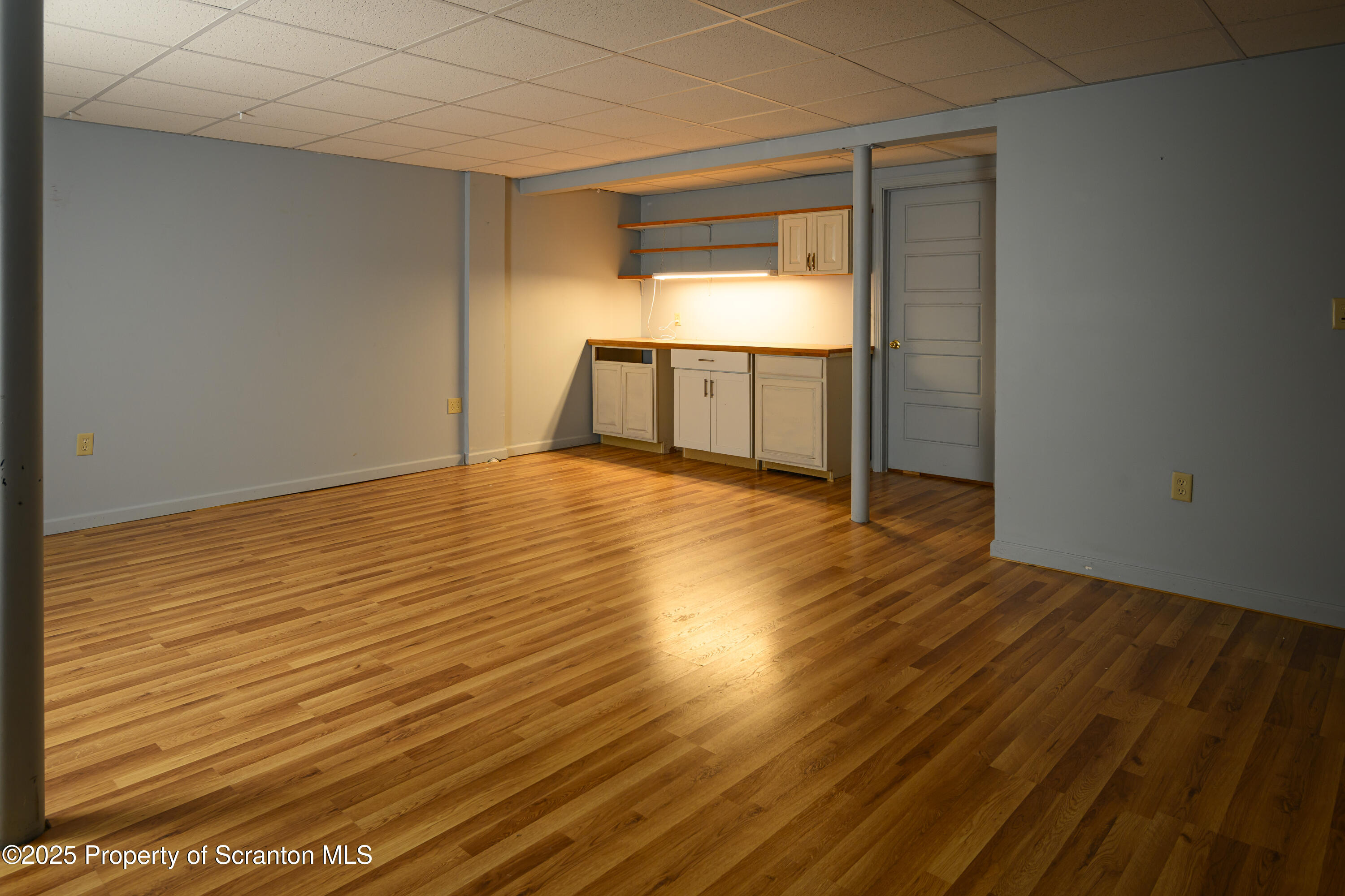 159 Vail Road Factoryville, PA 18419 - Photo 23 of 31 an empty room with wooden floor and cabinet