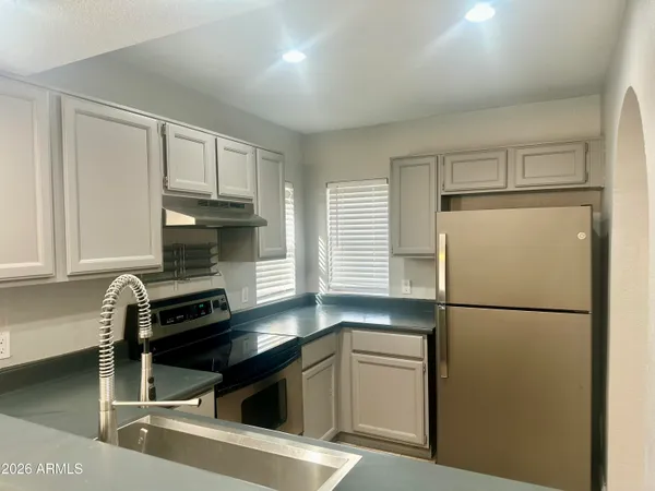 a kitchen with a refrigerator and a sink