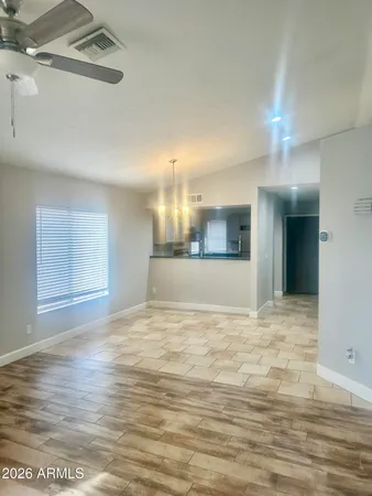 a view of empty room with wooden floor