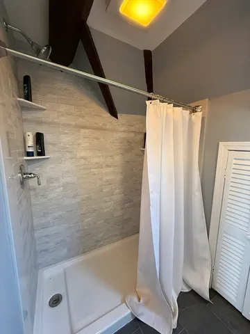 a bathroom with a shower and a tub
