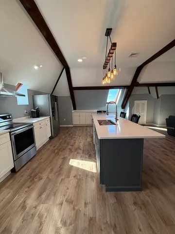 a kitchen with a sink stainless steel appliances and cabinets