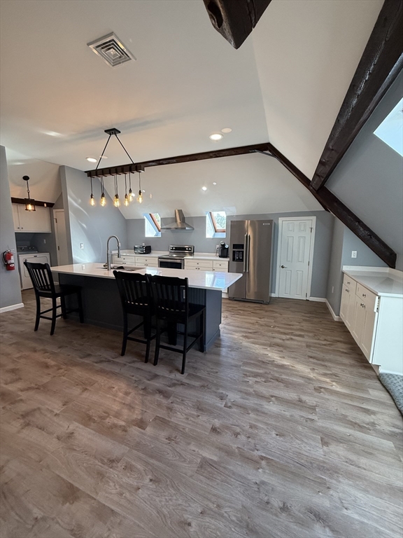 10 High Street, Unit 3 Andover, MA 01810 - Photo 7 of 16 a view of a big room with wooden floor fire place and furniture