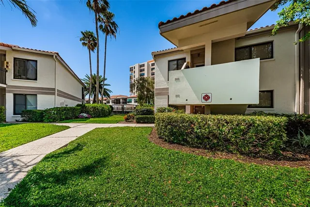 a view of a white house with a yard