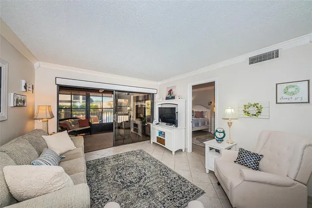 a living room with furniture large window and a flat screen tv