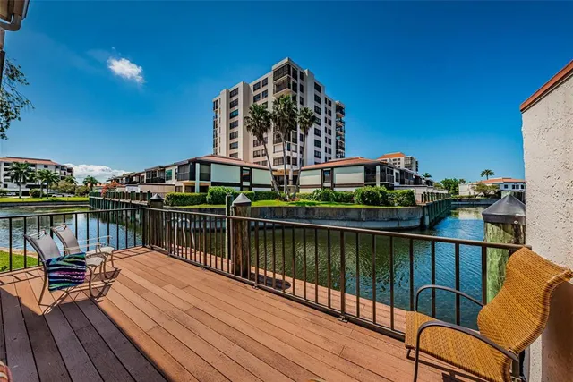 a view of a balcony with chairs and wooden floor
