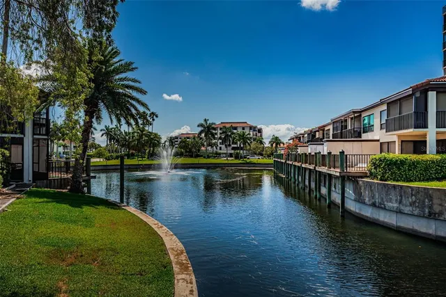 a view of swimming pool with outdoor seating and lake