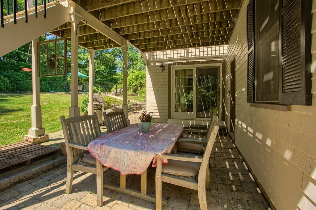 45 Hill Road Groton, MA 01450 - Photo 28 of 30 a view of a patio with a table chairs and backyard
