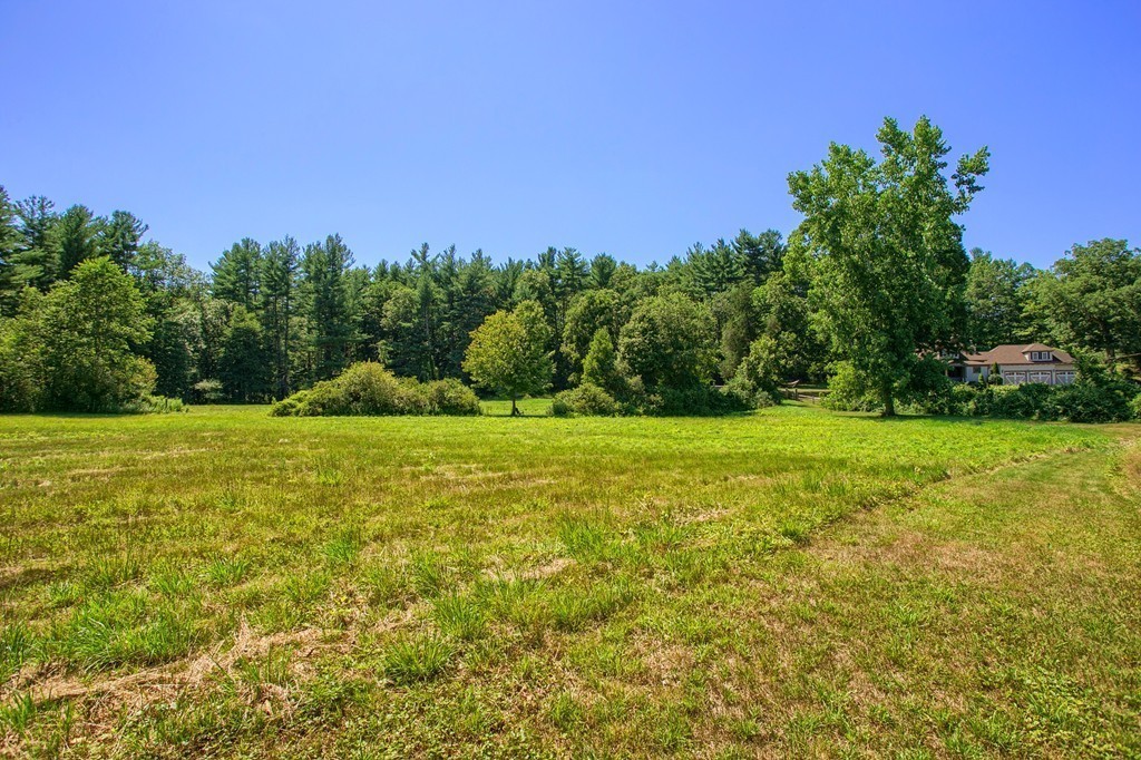 45 Hill Road Groton, MA 01450 - Photo 30 of 30 a view of a green field with trees in the background